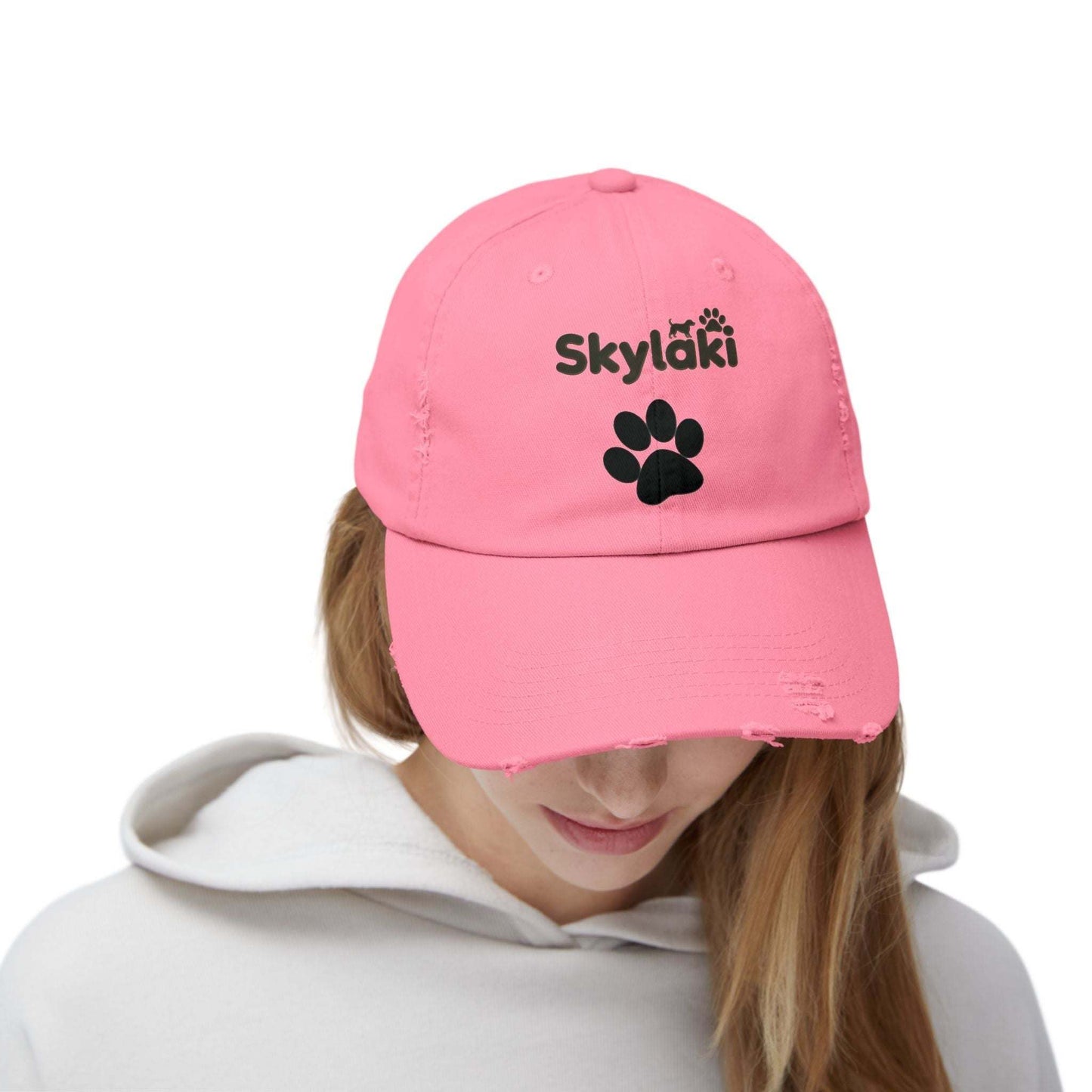 Unisex distressed cap with Skylaki logo in pink.