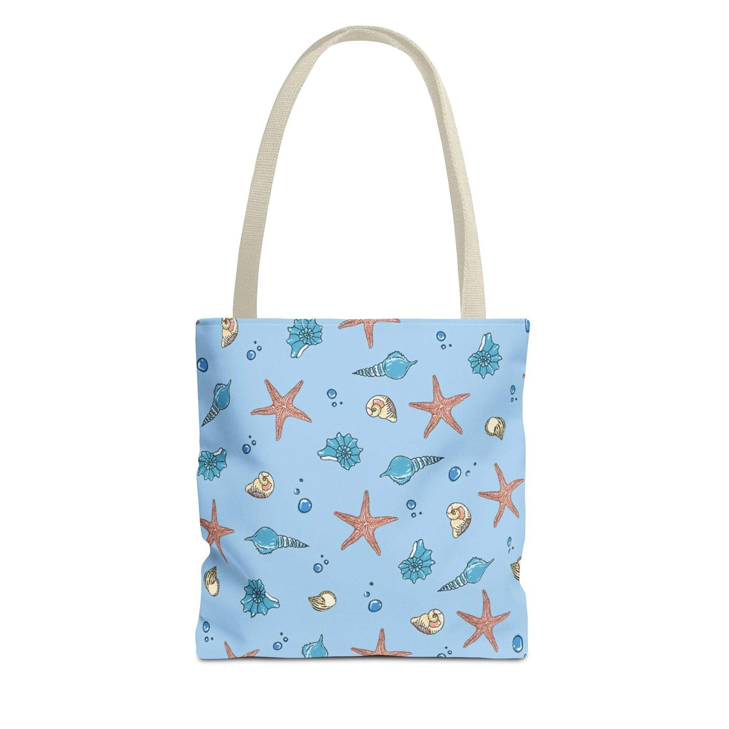 Beach tote bag with shell and starfish design on a blue background, featuring beige handles.