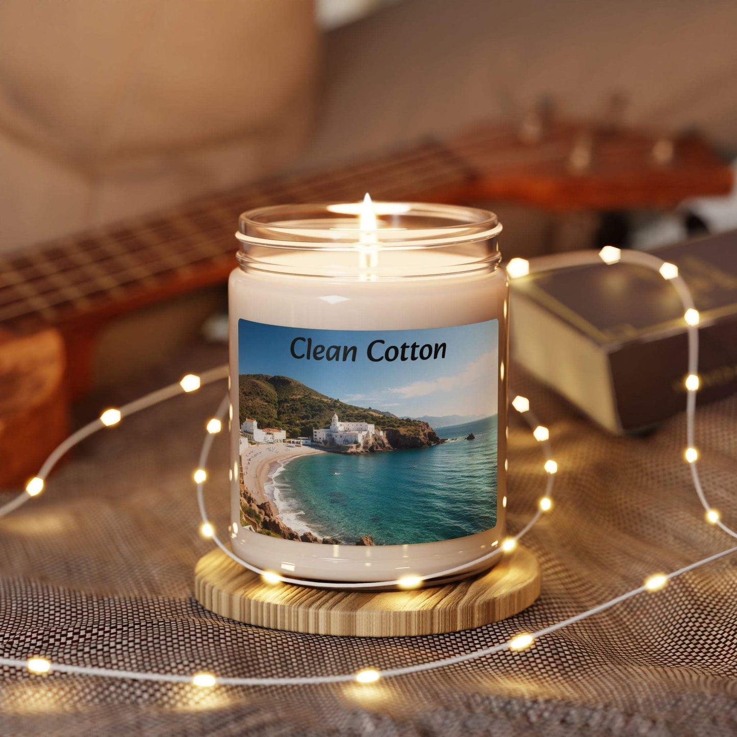 Clean Cotton Scented Soy Candle in glass jar, surrounded by cozy decor with string lights.
