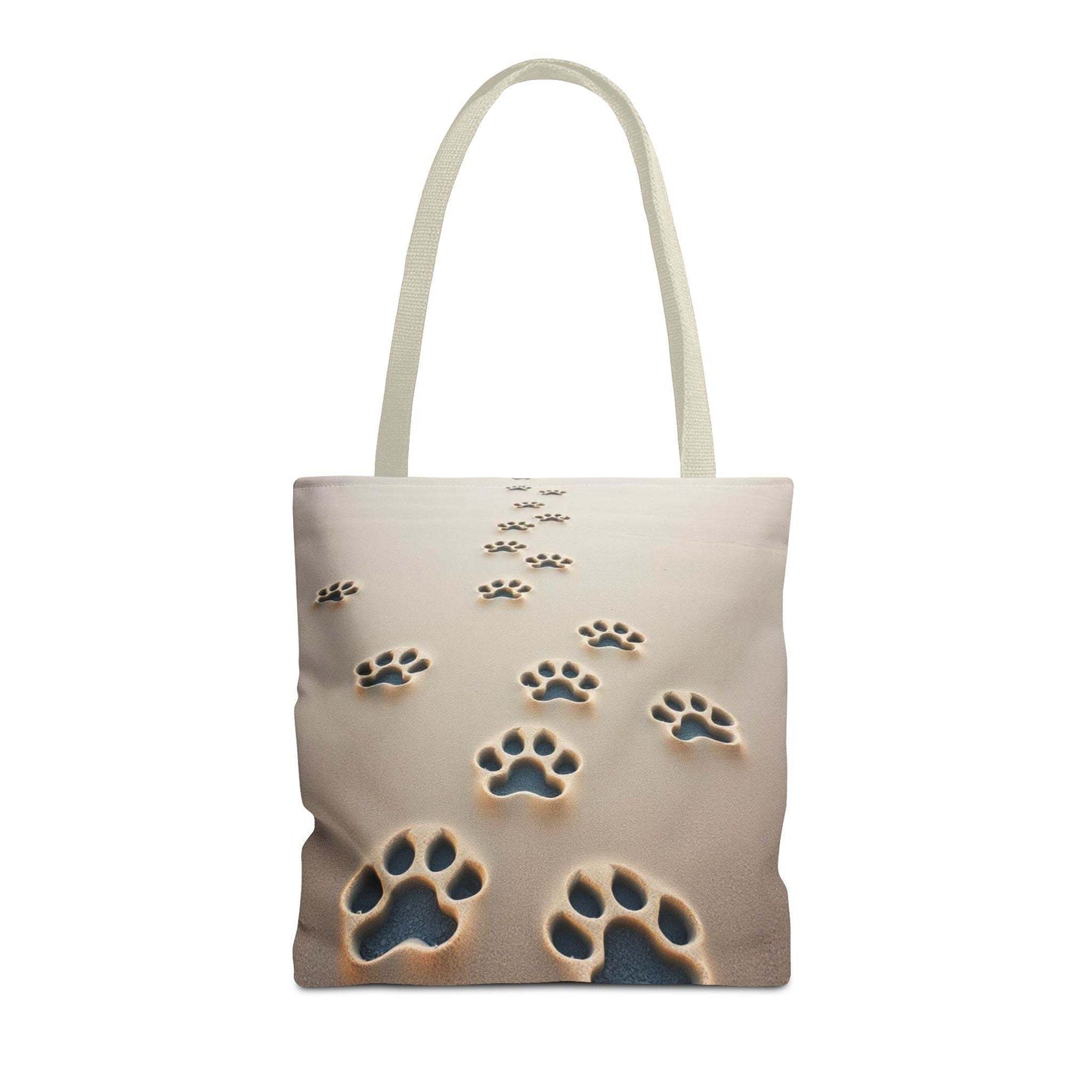 Paw Print Tote Bag with handles on sandy background, ideal for pet lovers and outdoor activities.
