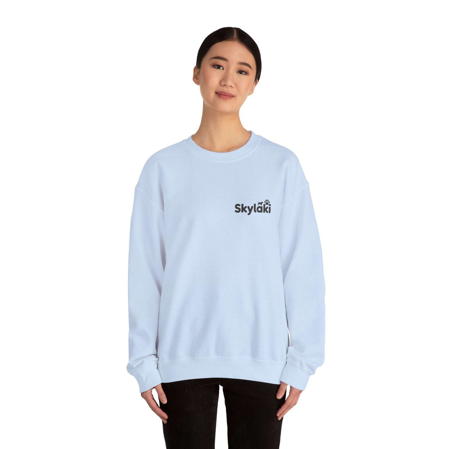 Unisex Heavy Blend™ Crewneck Sweatshirt in light blue worn by model, featuring a sleek design and ribbed knit collar.