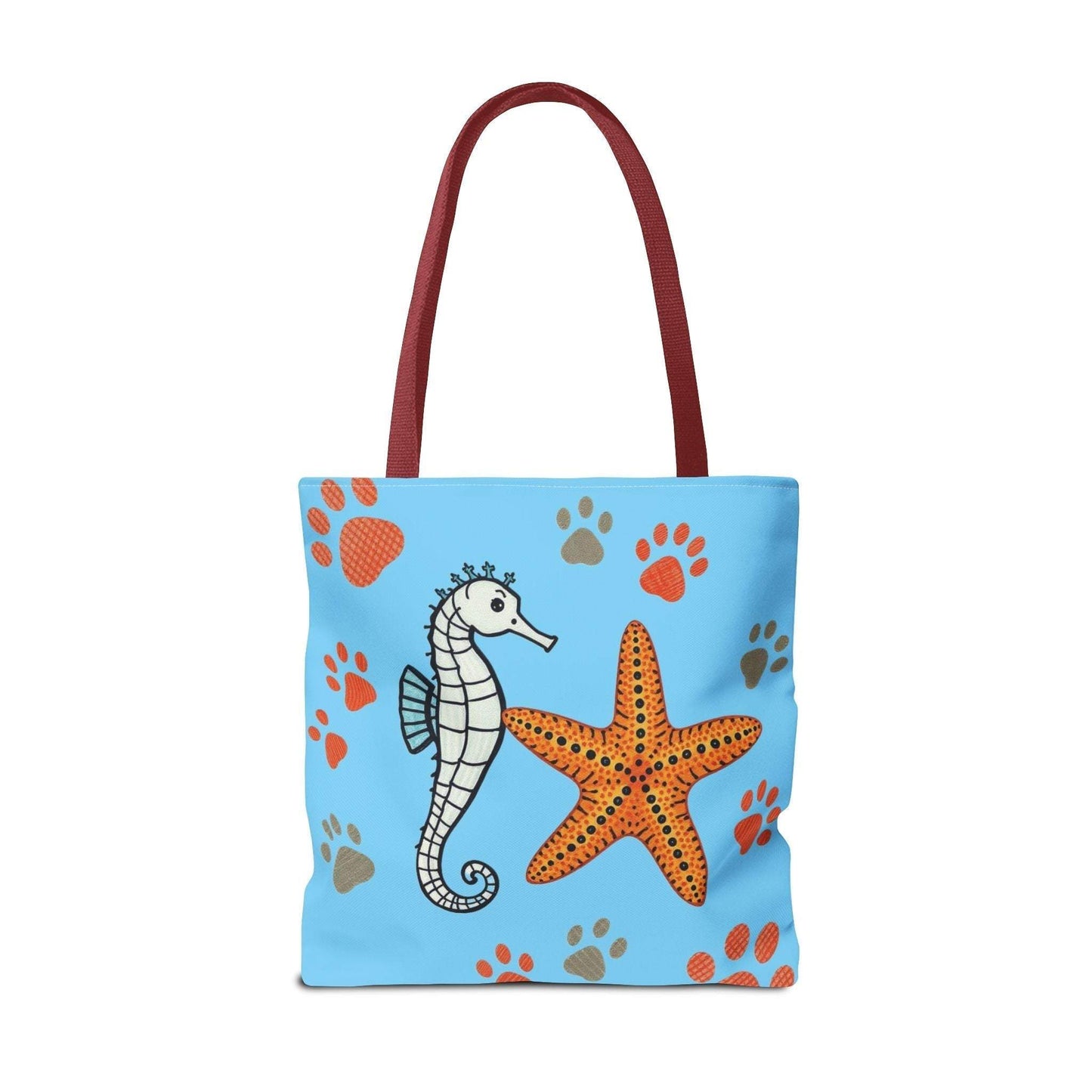 Tote bag with ocean-inspired seahorse and starfish design on a blue background.