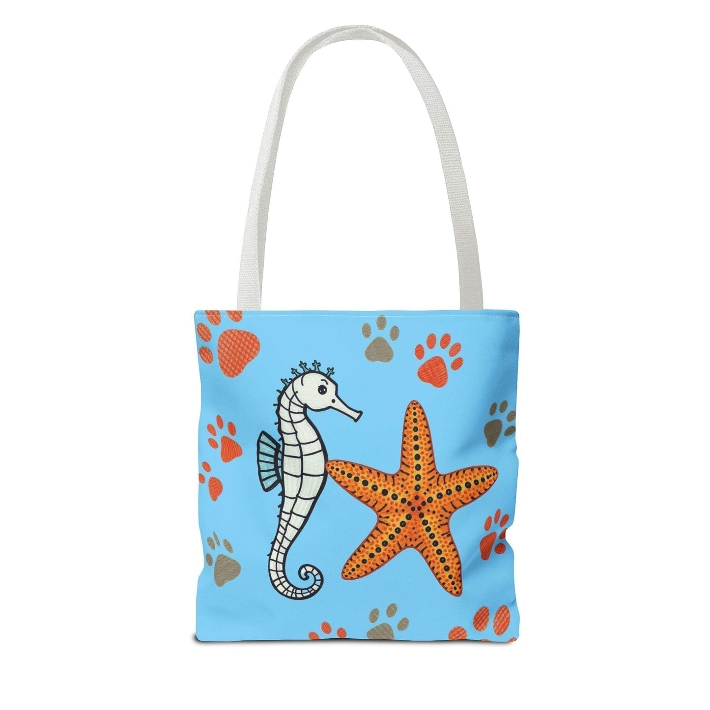 Ocean-inspired tote bag with seahorse and starfish design on blue background, ideal for beach days.