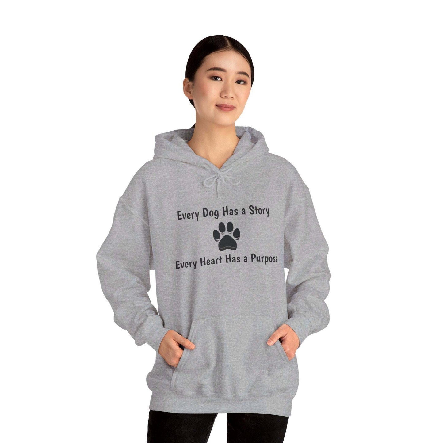 Unisex gray hooded sweatshirt with "Every Dog Has a Story; Every Heart Has a Purpose" print, worn by a person.