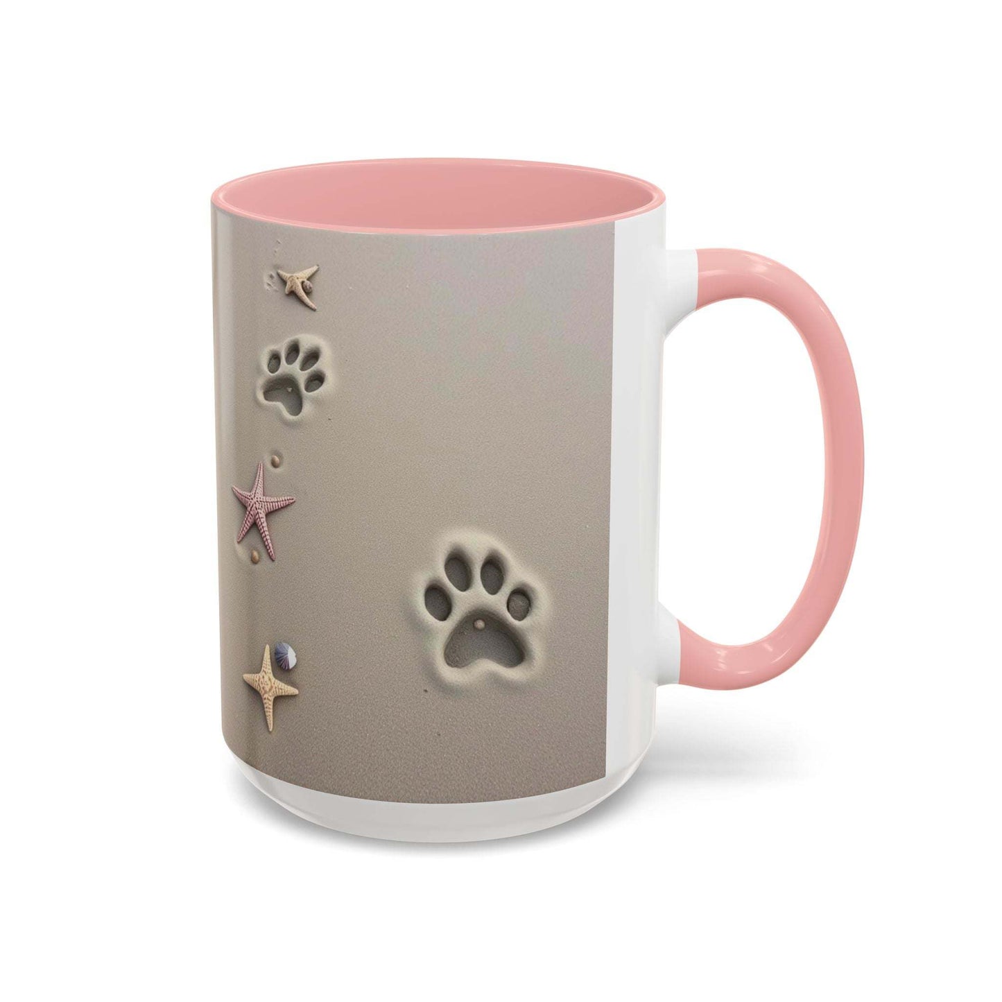 Nautical coffee mug with starfish and paw prints, pink handle, beach-themed design.