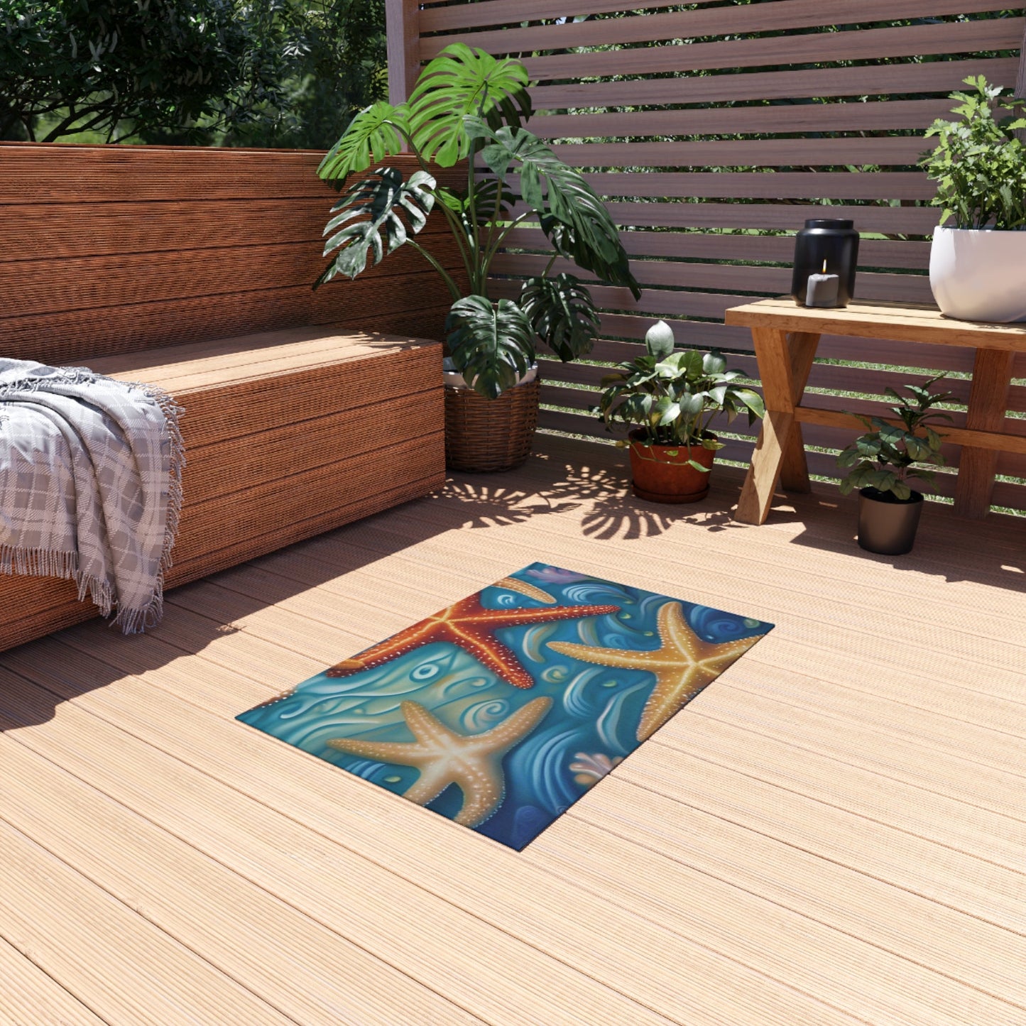 Nautical outdoor rug with starfish design on wooden patio.