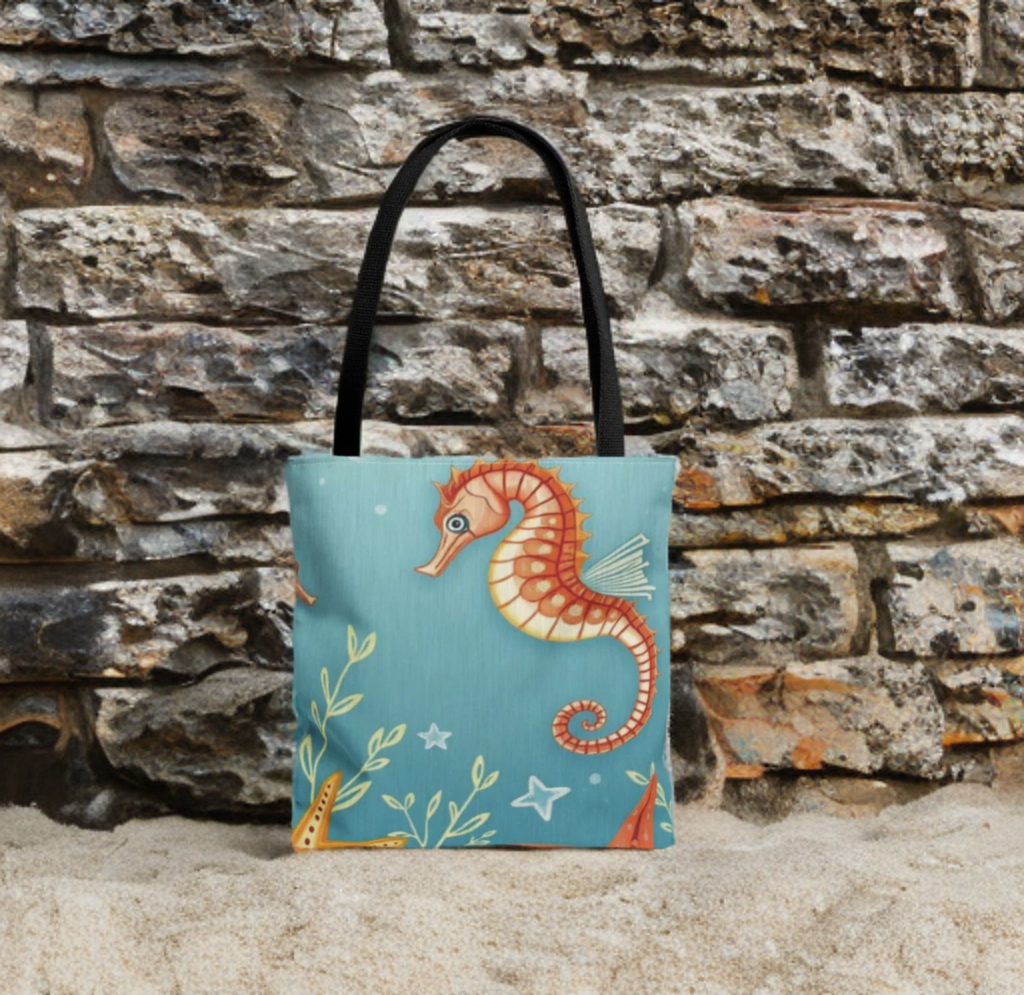 Beach Bag tote with vibrant seahorse design on sandy beach background.