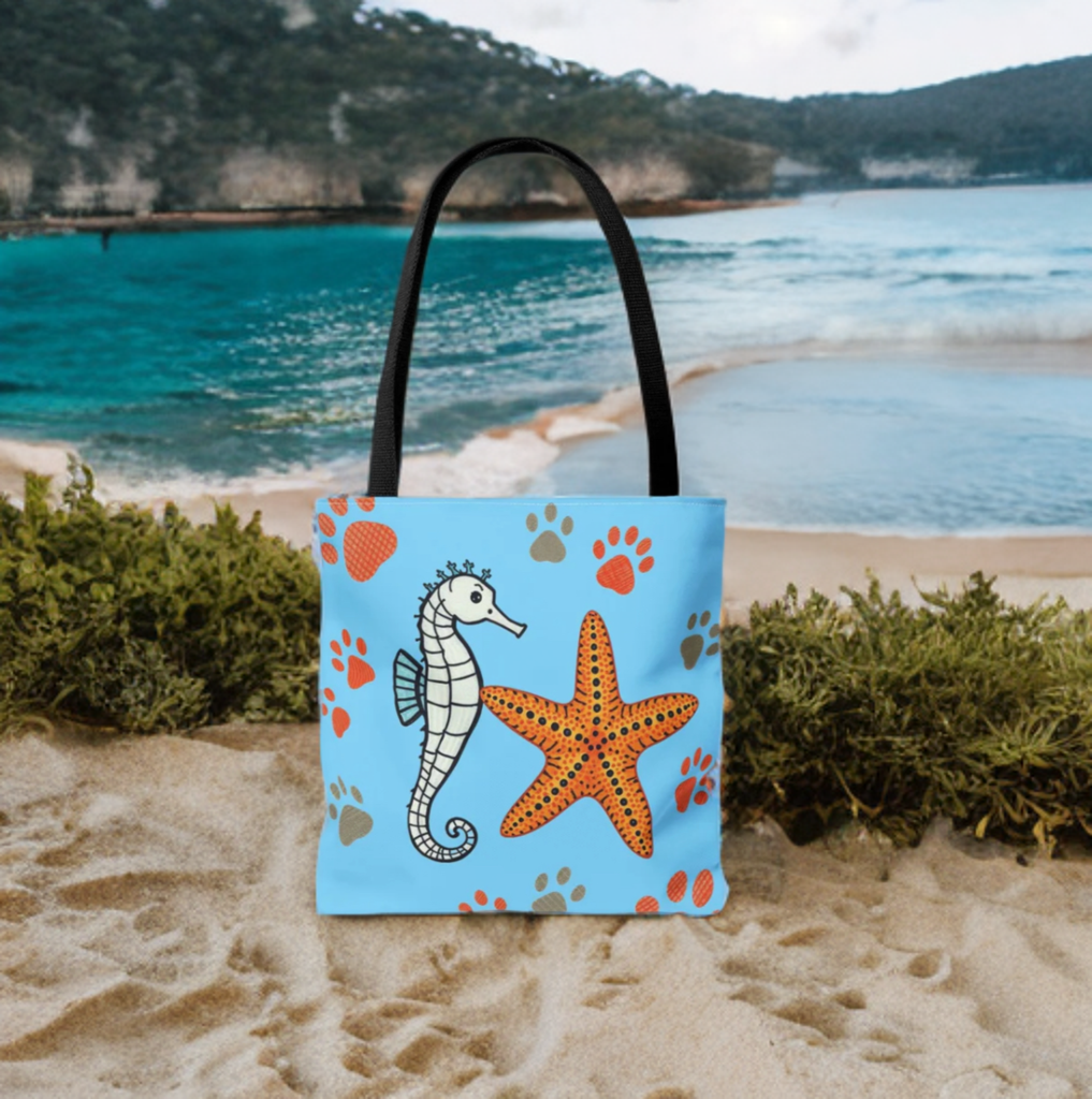 Tote bag with seahorse and starfish design on a beach background, perfect for ocean enthusiasts.