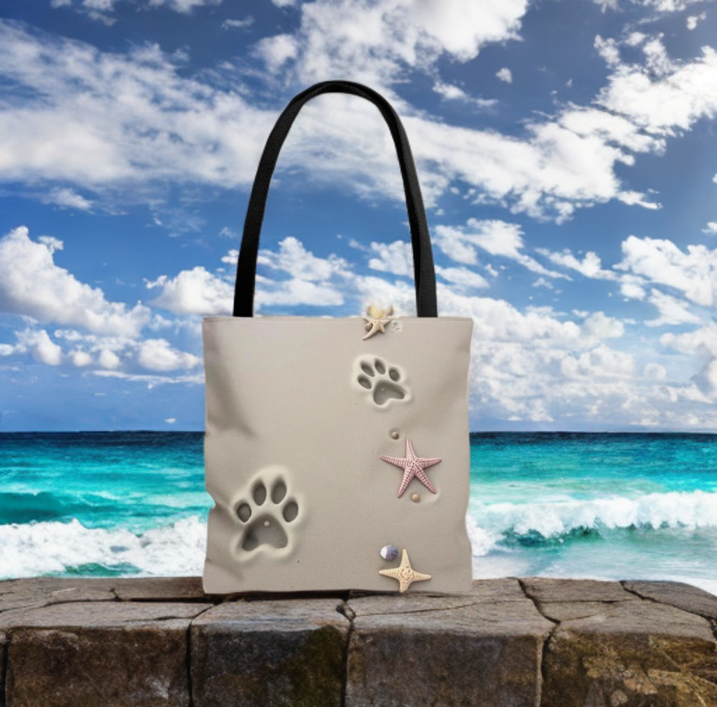 Beach Paw Print tote bag and starfish design against ocean backdrop.