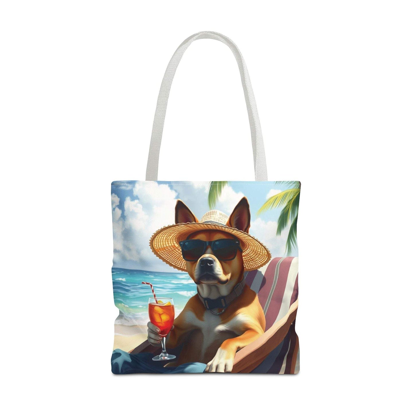 Dog tote bag with relaxed beach style, featuring dog lounging with drink by the ocean.