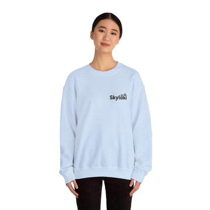 Unisex Heavy Blend™ Crewneck Sweatshirt in light blue worn by model, featuring a sleek design and ribbed knit collar.