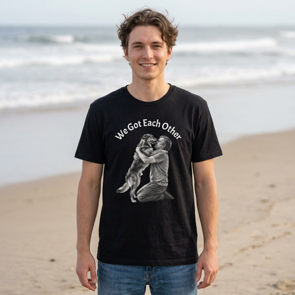 We Got Each Other lightweight cotton tee with black-and-white dog and owner embrace illustration