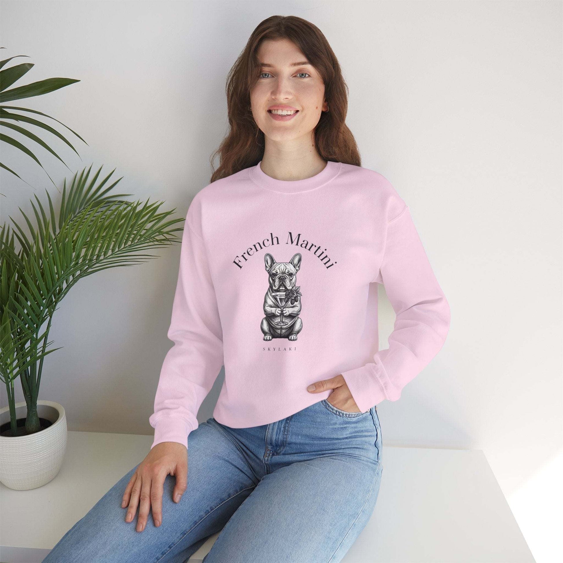 Unisex sweatshirt featuring hand-drawn black-and-white French Bulldog holding a martini with "French Martini" script, cozy 50/50 cotton-poly blend, ribbed collar, and smooth tubular knit design