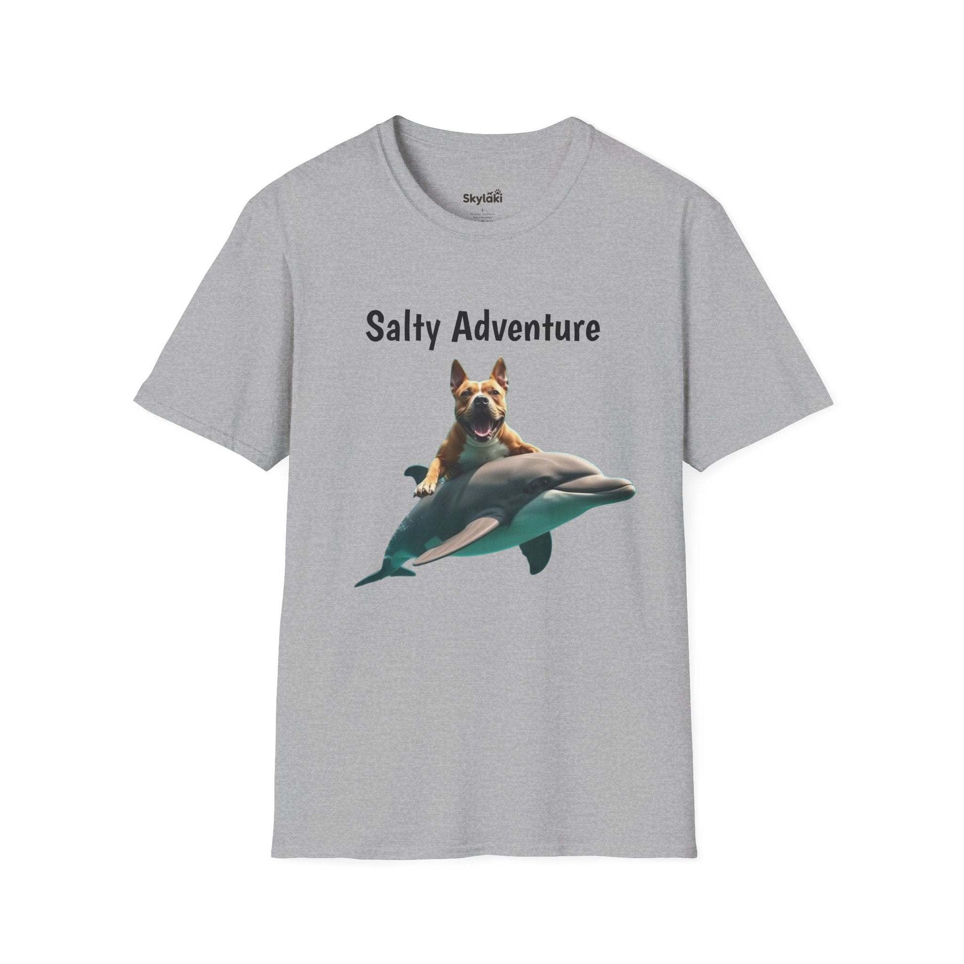Unisex t-shirt with "Salty Adventure" graphic of a dog riding a dolphin, perfect for fun beach life enthusiasts.