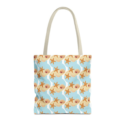 Seashell and starfish beach tote bag with coastal pattern on a blue background, featuring beige handles.