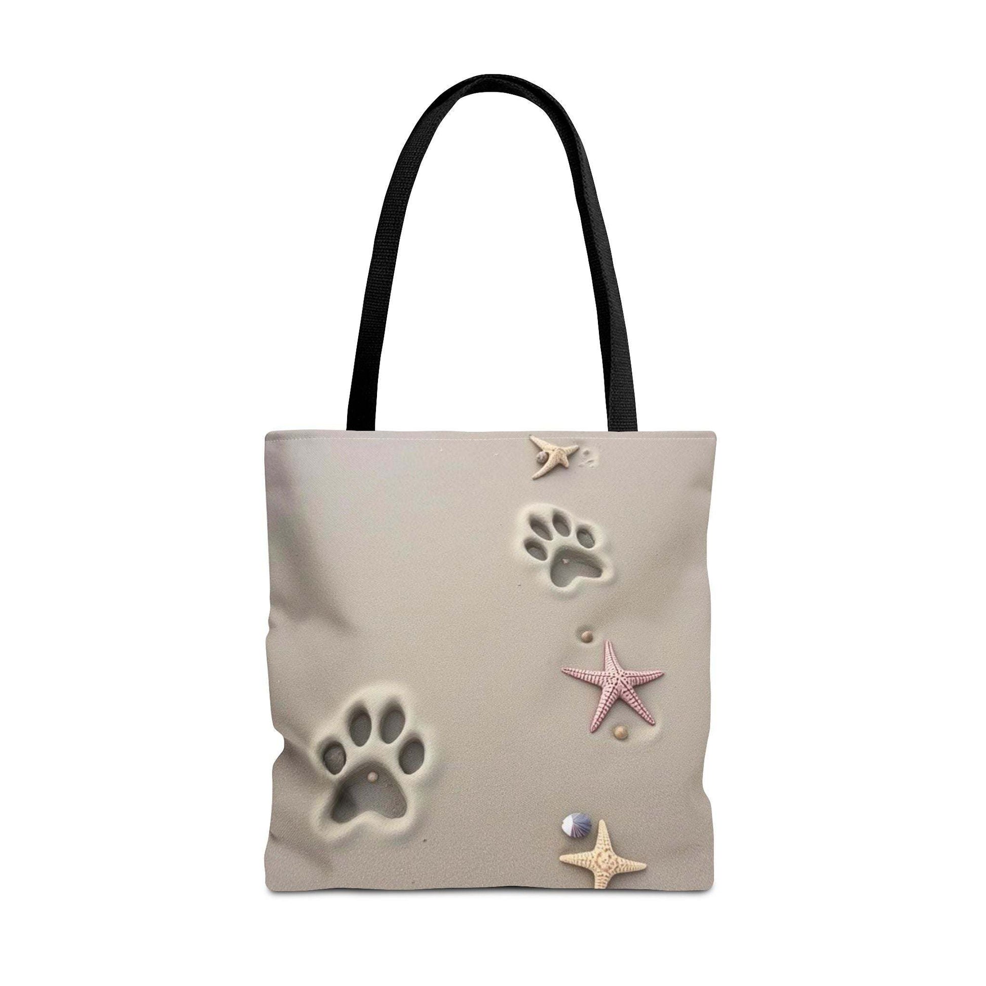Beach tote bag with paw print and starfish design for pet lovers.