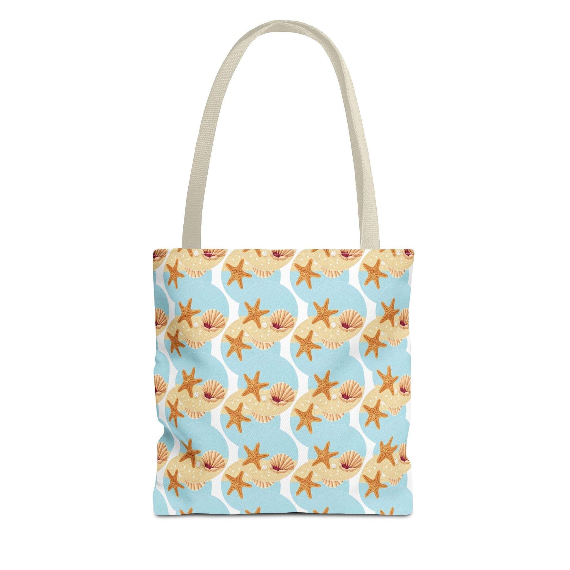 Seashell and starfish patterned beach tote bag with blue background and beige handles.