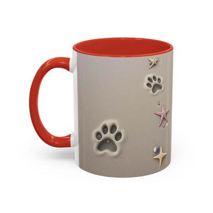 Nautical coffee mug with starfish and paw prints design, red handle, beach theme.