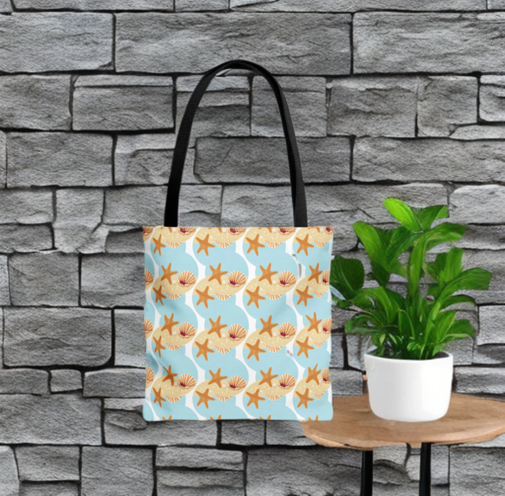 Seashell & Starfish Beach Bag with coastal pattern against stone wall backdrop.