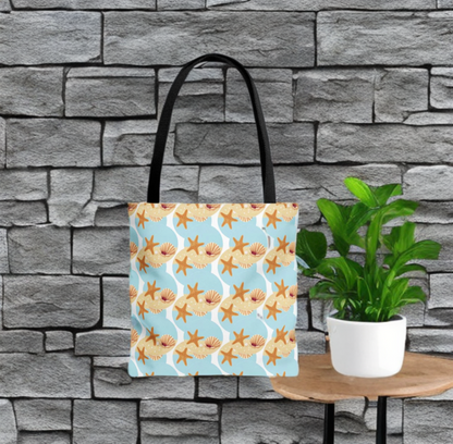 Seashell & Starfish Beach Bag with coastal pattern against stone wall backdrop.