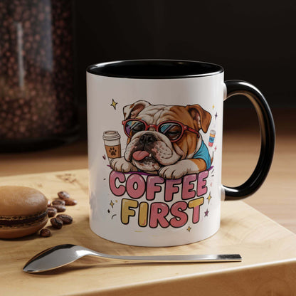 Bulldog Coffee Mug with glossy white ceramic, black interior and handle, bulldog illustration, and “COFFEE FIRST” lettering