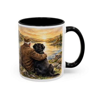 Man and Dog Watching Sunset ceramic mug with white exterior, black interior and handle, featuring painted lakeside artwork