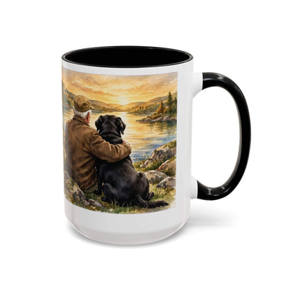 Man and Dog Watching Sunset mug, white ceramic with black rim and handle, featuring a painted lakeside scene in warm colors.